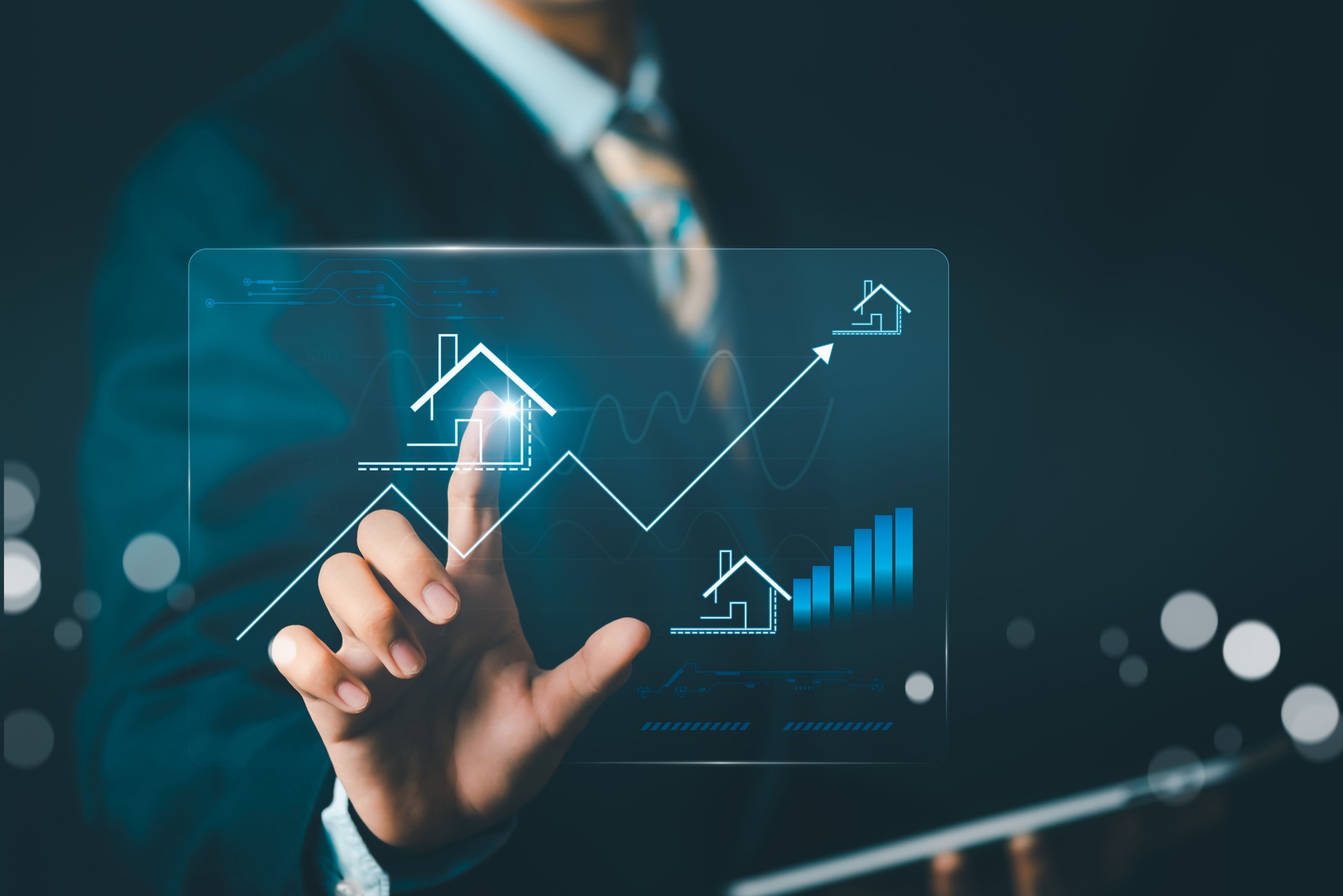 Businessman in suit taps on futuristic AI property dashboard showing housing market analytics, glowing house icons, rising data graphs, symbolizing smart real estate investment and financial growth.